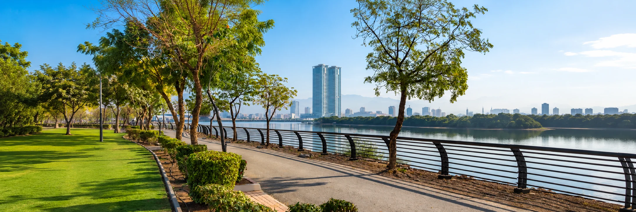 Corniche Al Qawasim promenade in Ras Al Khaimah, with mangroves and the city skyline across the water