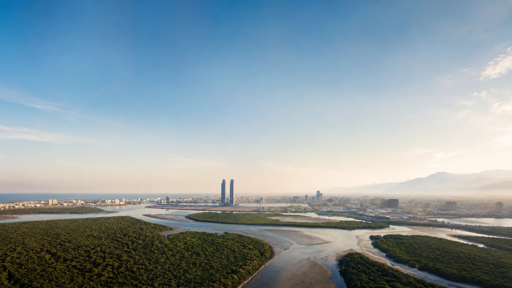 Aerial view of the Ras Al Khaimah creek and mangroves with the twin Julphar Towers on the skyline
